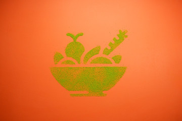 Vegetables in the basket. Green picture on an orange background