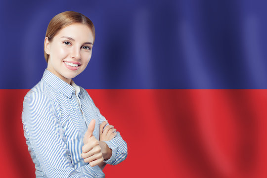 happy woman showing thumb up on Haiti flag background. Travel in