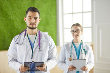 Portrait of group of smiling hospital colleagues standing together