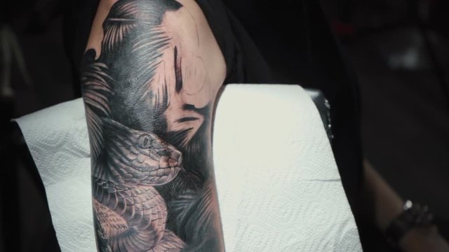 Video of man doing black tattoo for woman