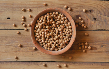 chickpeas in a brown clay pot, top view.
