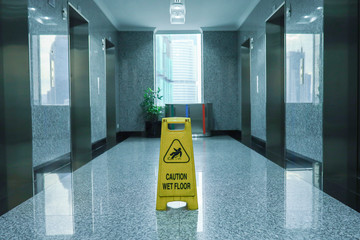 Wet floor signage on office hallway 