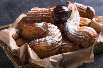 Delicious churros sticks deep fried and dusted with powdered sugar. Sweet street spanish food.