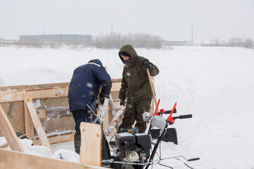 Two workers in overalls at a construction site