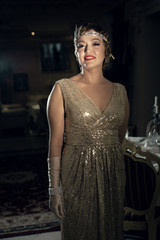 Fototapeta premium a woman in the image of 30 years, a diadem on her head, a hairstyle wave, long gloves with jewelry,