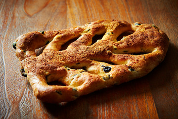 Olive bread on wooden background 