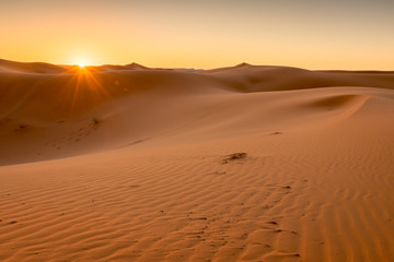 Fototapeta na wymiar Sunrise over the Sahara Dunes, Merzouga, Morocco
