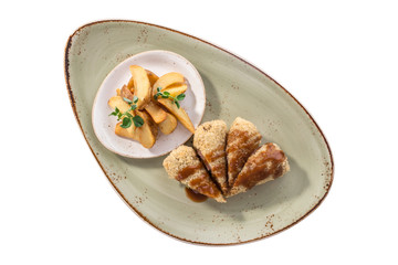 Golden fried stuffed pork with pickles and potato wedges isolated on white background