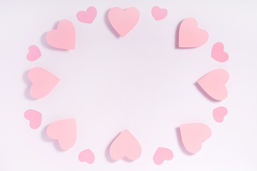 Pink hearts on white surface. Valentine composition. Greeting card.
