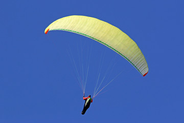 Paraglider flying wing in a blue sky	