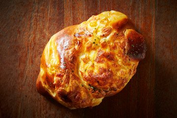 Baked cheese bread on wooden background 