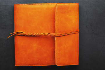 The album cover is made of brown genuine leather, handmade on a black background.