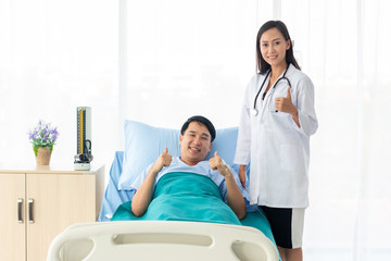 female doctor with happy patient at the hospital.