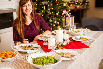 Table with holiday meals and Christmas decoration