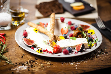 Cheese platter for two served on a plate in restaurant