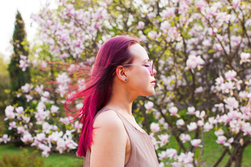Fototapeta premium Creative young woman with pink hair dreams with closed eyes