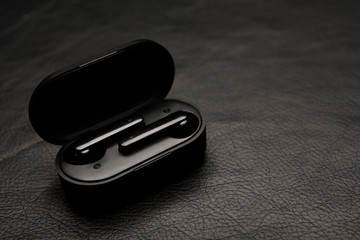 earphones case dark leather background