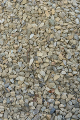 Closeup texture of small and small gray and white stones.