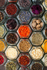 Assorted colorful spices and herbs in bottles