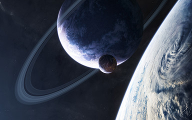Planets in blue light somewhere in deep space. Science fiction. Elements of this image furnished by...