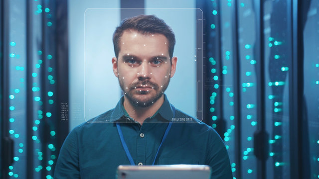 Future. Face Detection. Biometric Facial Recognition. ID Information Security. 3D Scanning of Face of Caucasian Server Engineer Working with Tablet at Data Center. Data Analyzing Animation with Points