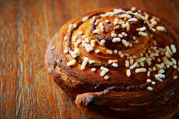 Sweet bread roll on wooden background 
