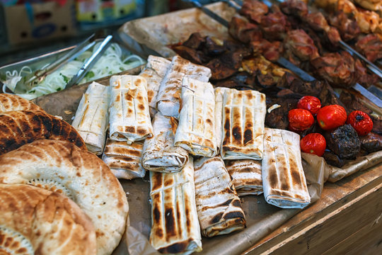 Roasted rolls of bread lavash filled with herbs feta cheese.