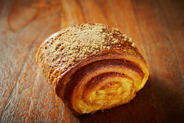 Sweet cinnamon roll bread on wooden background 