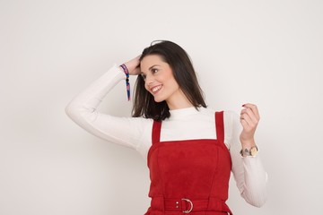 Shot of happy young woman with positive smile, has long hair, rejoices having weekend and good rest after hard working exhausting week, isolated on gray wall.