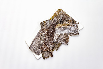 Dry laminaria japonica（kelp）Isolated on white background. Kombu seaweed, traditional Japanese ingredient for cooking Dashi soup.