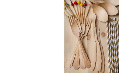 Eco, environment friendly disposable cutlery made from bamboo on wooden rustic background, top view, overhead