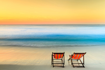 View of the tropical sea beach and couple loungers at sunrise. Samed island thailand