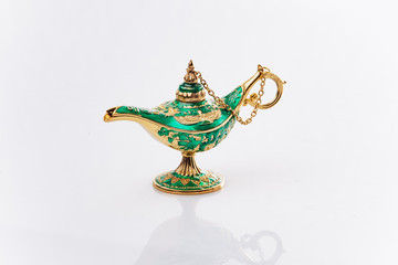 Aladdin's magic genie lamp isolated on white. Aladdin's lamp is green on a white background.