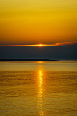 Sunset over the ocean coastline during the golden hour.