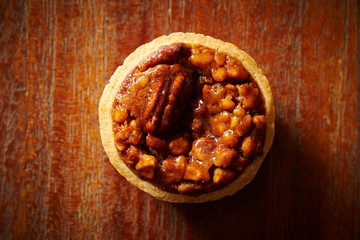 Pecan nuts tart on wooden background 