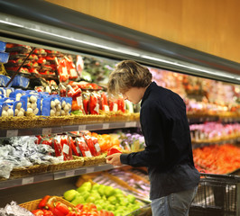 Young man buying vegetables at the market	