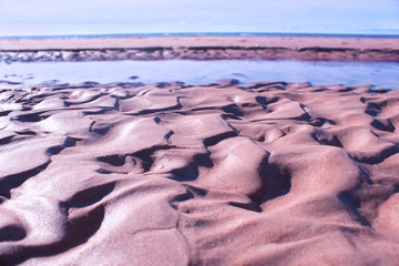 The beautiful beach sand texture macro photography looks like sand dunes in the desert.