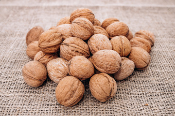 Mature walnuts on woven fabric. Nuts on linen fabric