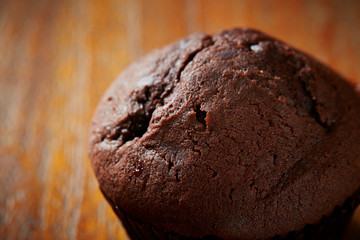 Chocolate cupcake on wooden background 