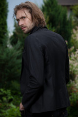 Young elegant handsome man posing outside.