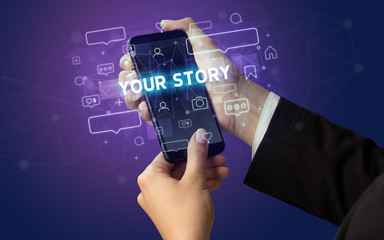 Obraz premium Female hand typing on smartphone with YOUR STORY inscription, social media concept
