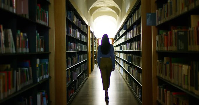Girl Choosing Book In Library