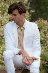 Young elegant handsome man posing outside.