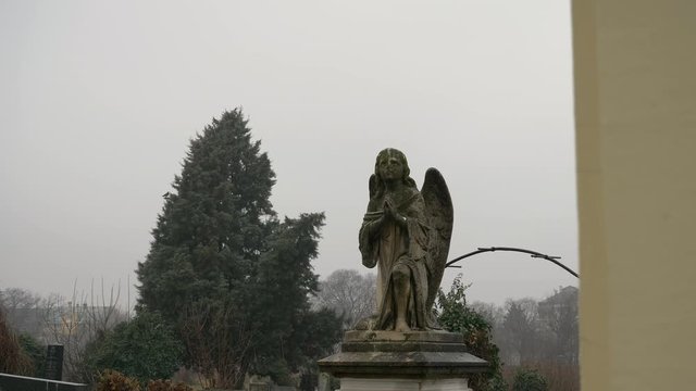 Angel Statue Praying In Cemetery