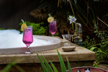 Romantic drink and bath tub in tropical garden