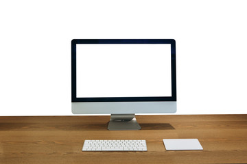 Modern personal computer on a wooden table with a white white screen for mock up and isolated white background.