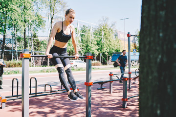 Sport woman doing pull up exercise in fresh air