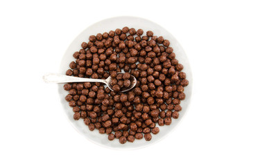 dry breakfast in a plate on a white background. Chocolate balls.