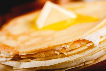 Stack of Russian thin pancakes (blini) with butter. Traditional Maslenitsa (Shrovetide or Butter Week) festival meal.