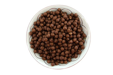 dry breakfast in a plate on a white background. Chocolate balls.